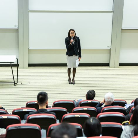 woman lecturing in auditorium
